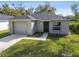 Newly constructed home with a gray exterior, attached garage, and well-maintained lawn at 730 Tennessee Rd, Lakeland, FL 33815