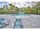 Community pool with a area and lounge chairs at 1343 Berry Ln, Davenport, FL 33837