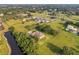 Aerial view showcasing the property's serene waterfront location at 1730 Broken Arrow N Trl, Lakeland, FL 33813