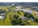 Aerial view of house, expansive lot, and tranquil lake setting at 1730 Broken Arrow N Trl, Lakeland, FL 33813