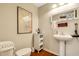 Powder room with pedestal sink and wood flooring at 1730 Broken Arrow N Trl, Lakeland, FL 33813