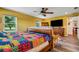 Bedroom with yellow walls, a large bed, and a view of the backyard at 1730 Broken Arrow N Trl, Lakeland, FL 33813