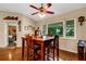 Bright dining room features a wooden table with chairs, hardwood floors, and a view to the backyard at 1730 Broken Arrow N Trl, Lakeland, FL 33813