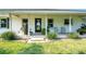 Inviting front porch with black door and lush landscaping at 1730 Broken Arrow N Trl, Lakeland, FL 33813