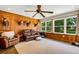 Gathering room with wood walls, leather furniture, and large windows at 1730 Broken Arrow N Trl, Lakeland, FL 33813