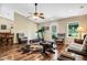 Relaxing living room with hardwood floors, multiple seating areas and large windows at 1730 Broken Arrow N Trl, Lakeland, FL 33813