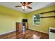 Home office with wood flooring, ceiling fan, and built-in shelves at 1730 Broken Arrow N Trl, Lakeland, FL 33813