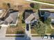 Aerial view of two-story house with gray siding and a two-car garage at 1918 Wind Meadows Dr, Bartow, FL 33830