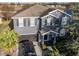 Two-story house with gray siding, dark garage door, and landscaping at 1918 Wind Meadows Dr, Bartow, FL 33830