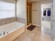 Bathroom boasts a bathtub, shower, and walk-in closet at 1918 Wind Meadows Dr, Bartow, FL 33830