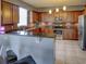 Kitchen with wood cabinets, granite counters, and stainless steel appliances at 1918 Wind Meadows Dr, Bartow, FL 33830