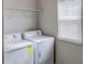 Laundry room with washer, dryer, and shelving at 1918 Wind Meadows Dr, Bartow, FL 33830