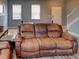 Living room with brown leather couch and wood floor at 1918 Wind Meadows Dr, Bartow, FL 33830