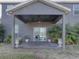 Covered patio with ceiling fan, seating area and potted plants at 1918 Wind Meadows Dr, Bartow, FL 33830