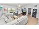 Open living room with sectional sofa and access to bedroom at 227 Ridgedale Dr, Lakeland, FL 33809