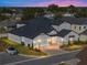 Two-story home aerial view at dusk with a car in driveway at 2728 Sunrise Landing Ln, Lakeland, FL 33812