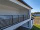 Covered balcony with a metal railing and distant view at 2728 Sunrise Landing Ln, Lakeland, FL 33812
