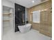 Spa-like bathroom with soaking tub, walk-in shower, and marble tile at 2728 Sunrise Landing Ln, Lakeland, FL 33812
