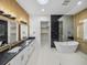 Elegant bathroom boasting double vanity, walk-in shower, and soaking tub at 2728 Sunrise Landing Ln, Lakeland, FL 33812
