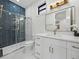 Modern bathroom with a herringbone tile shower and white vanity at 2728 Sunrise Landing Ln, Lakeland, FL 33812
