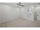 Bedroom with en-suite bathroom and ceiling fan at 2728 Sunrise Landing Ln, Lakeland, FL 33812