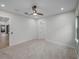 Well-lit bedroom with ceiling fan and neutral carpeting at 2728 Sunrise Landing Ln, Lakeland, FL 33812