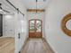 Bright entryway with wood flooring, double doors, and a chandelier at 2728 Sunrise Landing Ln, Lakeland, FL 33812