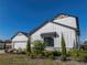 Side view of a two story home with white siding and landscaping at 2728 Sunrise Landing Ln, Lakeland, FL 33812