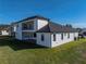 Two-story home with a covered patio and grassy backyard at 2728 Sunrise Landing Ln, Lakeland, FL 33812