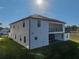Two-story home with balcony, patio, and grassy backyard at 2728 Sunrise Landing Ln, Lakeland, FL 33812