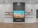Modern fireplace with built-in shelving and a large TV above at 2728 Sunrise Landing Ln, Lakeland, FL 33812