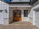 Double wooden doors with glass panels and a welcoming entryway at 2728 Sunrise Landing Ln, Lakeland, FL 33812