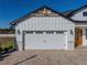 Two-car garage with white doors and stone accents at 2728 Sunrise Landing Ln, Lakeland, FL 33812