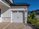 Single car garage with white door and stone accents at 2728 Sunrise Landing Ln, Lakeland, FL 33812