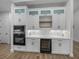 Modern kitchen with white cabinets, stainless steel appliances, and quartz countertops at 2728 Sunrise Landing Ln, Lakeland, FL 33812