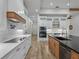Modern kitchen with white cabinets, wood island, and a herringbone backsplash at 2728 Sunrise Landing Ln, Lakeland, FL 33812