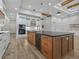 Open concept kitchen with island and hardwood floors at 2728 Sunrise Landing Ln, Lakeland, FL 33812