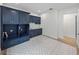Bright laundry room with blue cabinets and patterned tile floor at 2728 Sunrise Landing Ln, Lakeland, FL 33812