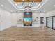 Living room with hardwood floors, fireplace, built-in shelving, and chandelier at 2728 Sunrise Landing Ln, Lakeland, FL 33812