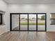 Living area with sliding glass doors leading to backyard at 2728 Sunrise Landing Ln, Lakeland, FL 33812