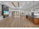 Open living space with hardwood floors, a fireplace, and a large TV at 2728 Sunrise Landing Ln, Lakeland, FL 33812