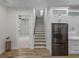 Modern staircase leading to upper level and kitchen area at 2728 Sunrise Landing Ln, Lakeland, FL 33812