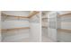 Spacious walk-in closet featuring custom shelving and rods at 2728 Sunrise Landing Ln, Lakeland, FL 33812