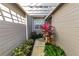 Covered walkway with pergola, lush landscaping, and a private gate at 3164 Stonewater Dr # 3164, Lakeland, FL 33803