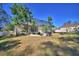 Large backyard featuring a screened patio and mature trees at 5635 Canvasback Ct, Lakeland, FL 33805