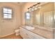 Clean bathroom with single vanity and large mirror at 5635 Canvasback Ct, Lakeland, FL 33805