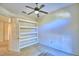 Spacious bedroom with built-in shelving and ceiling fan at 5635 Canvasback Ct, Lakeland, FL 33805