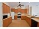 Kitchen with wood cabinets, tile floor and appliances at 5635 Canvasback Ct, Lakeland, FL 33805
