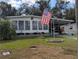 Landscaped yard with American flag and spacious driveway at 1610 Reynolds Rd # 211, Lakeland, FL 33801
