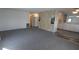 Spacious living room with carpet and view into kitchen at 1610 Reynolds Rd # 211, Lakeland, FL 33801